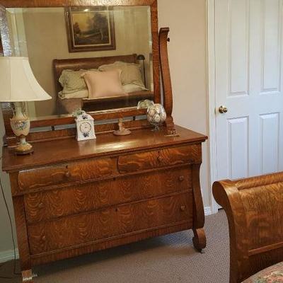 Late 19th Century to early 20th Century Walnut Circassian dresser with attached mirror and a bed headboard and footboard. Good condition.