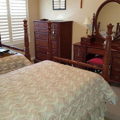 1940's Willett Wildwood Cherry Bedroom set that includes vanity and stool, chest of drawers, night stand, and two twin sized poster beds.