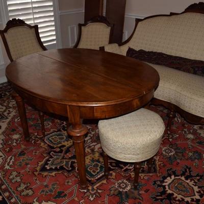 Oval Shaped Antique Dining Table that comes with two upholstered stools. The table can be stretched to add several leaves. There are four...