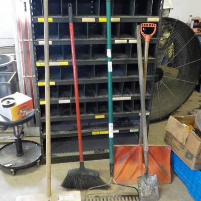 lot of brooms and shovels