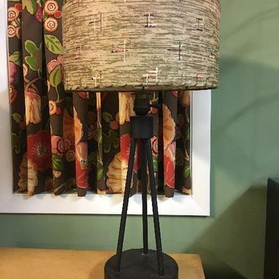 Sharp looking mid-century modern lamp with a metal tripod base and hand painted decorative shade