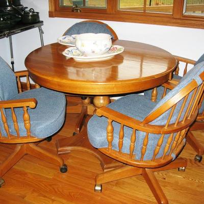 oak kitchen table with 2 leaves and for chairs on casters.  Chairs all totally adjustable. BUY IT NOW $ 335.00
