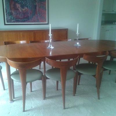 Mid Century Modern, Teak and bought in Germany in 1960. Table with 2 inserts, Credenza, 10 unique and collectable Chairs. 