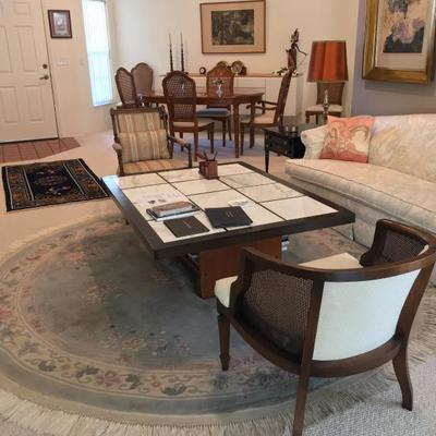 rugs, couch, side tables, mid century side chair, victorian side chair, marble & wood coffee table.

