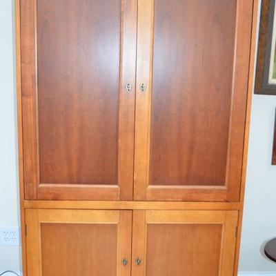 Transitional style wood armoire with clean lines