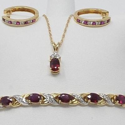 Beautiful ruby and diamonds set in 14k gold. Bracelet, necklace and hoop earrings.