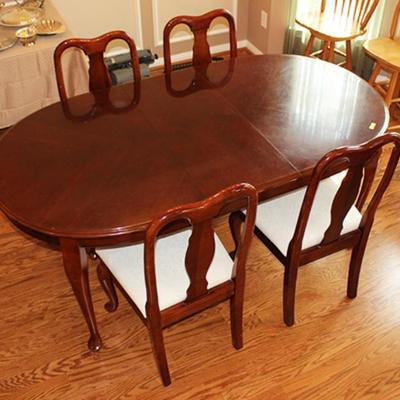 Dining room table with four white upholstered side