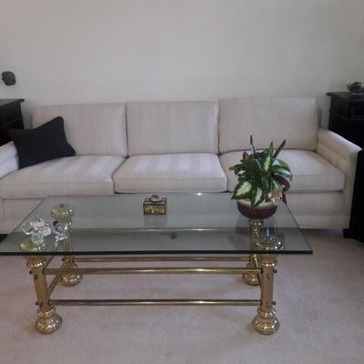 Living room sofa with brass and glass coffee table