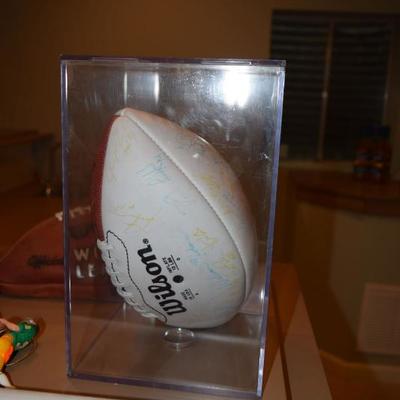 autographed football in case 