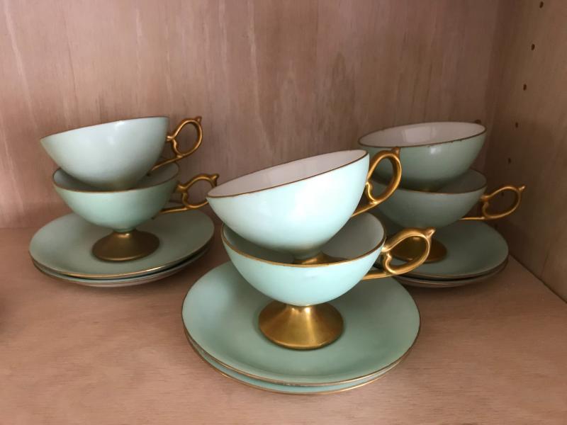 Footed cup and saucers. Signature inscription: G. Simpson