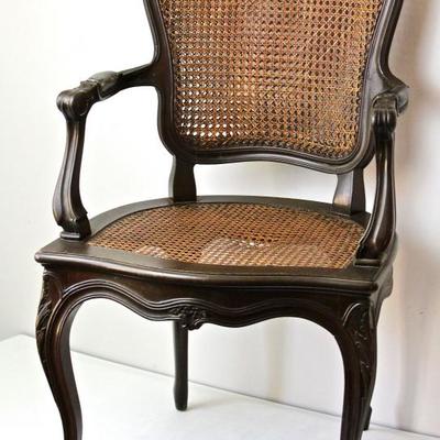 antique arm chair with caned seat and back