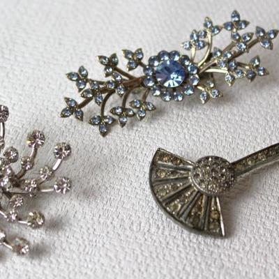 quite a variety of brooches, including rhinestones