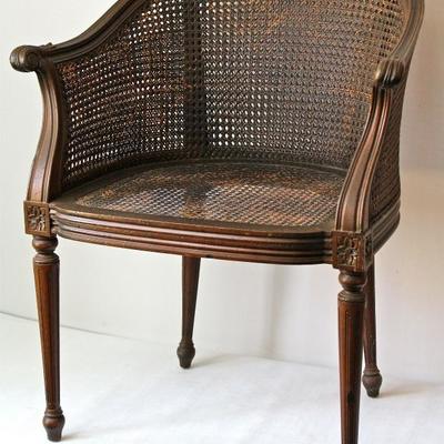 antique barrel back chair in woven cane and wood