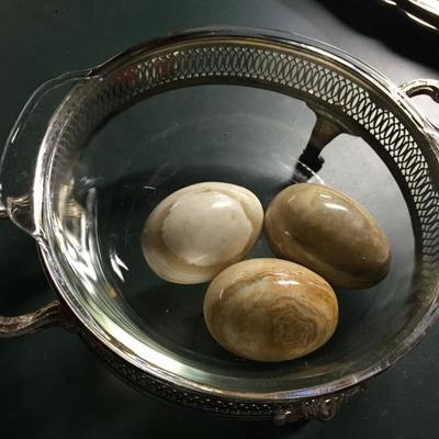 Glass dish in silver and marble eggs.