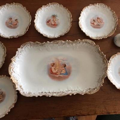 Limoges cupid set, six plates, each with a different design.