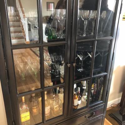 Spacious Liquor Cabinet featuring glass doors, two sets of drawers and plenty of storage space!