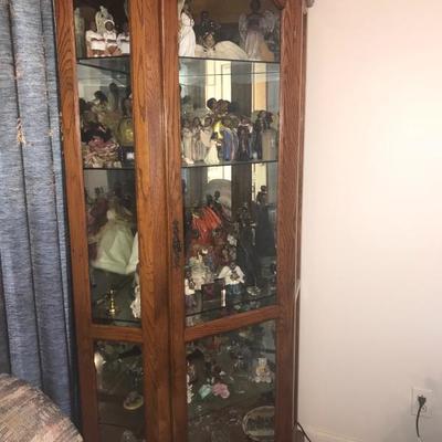 CURIO CORNER CABINET FILLED WITH FIGURINES





