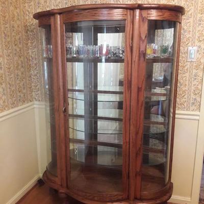 Not your grandmother's breakfront. Beautiful solid wood curio cabinet, 4 glass shelves along with a bottom display space. Enjoy...