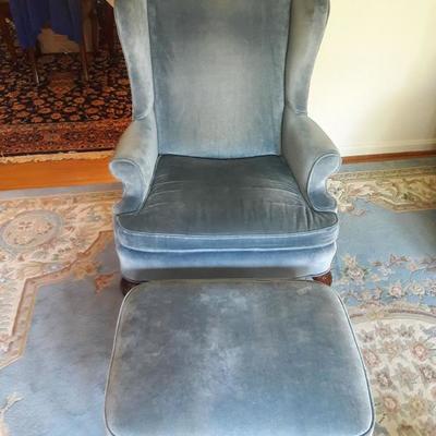 Blue armchair with matching ottoman. Likes the rug.