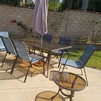GLASS TABLE WITH UMBRELLA AND 6 CHAIRS