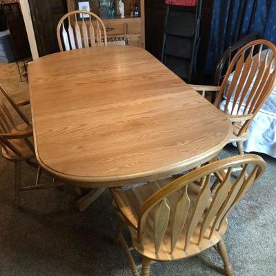 Oak dining table with oak captains chairs two leaves