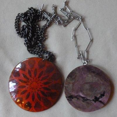 Two large pendant necklaces, one with purple stone
