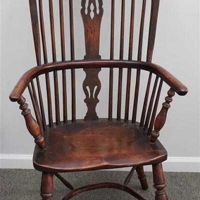 19th c. New England Horseshoe form spindle back Windsor Chair, with a carved and pierced center splat, panel seat, and turned legs joined...