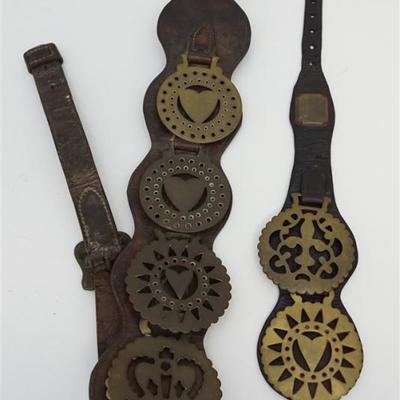 Antique English Horse Brasses on leather straps. A total of 6 Brasses and two straps. All brasses approximately 3 1/2