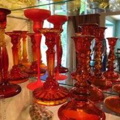 Lots of colored glass candlestick holders. Depression era.