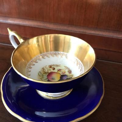 Aynsley, John. Footed tea cup with saucer. Blue outer rim and gold inner rim with fruit center. Mid century. Hard to find. $22.