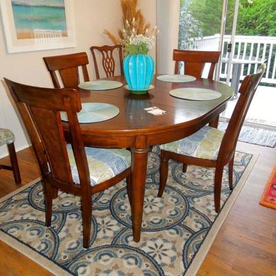 Walnut oval dining table with two leaves. Set of four chairs sold separately