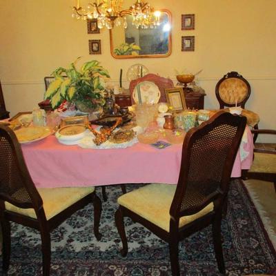Dining table with 8 caned back chairs, area rug
