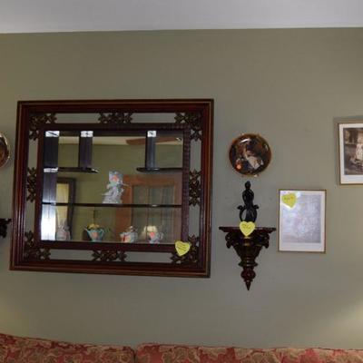 Wooden shelf with mirror, sconces, wall art