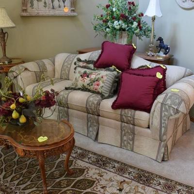 Sofa, pillows, coffee table, end table, table lamp, sofa table, floral arrangements