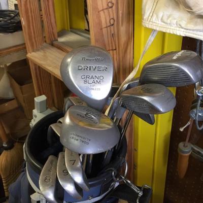 Gold clubs, boxes of balls, shoes 