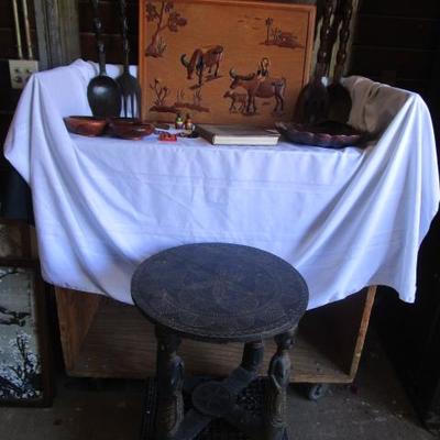 African hand made table with other Asian inspired pieces including a hand made wooden piece of art work