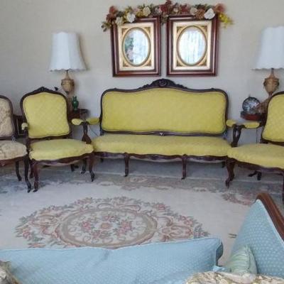 Yellow settee and chair with various other chairs
