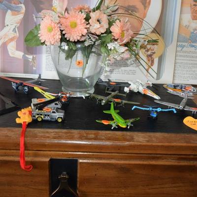 Sports memorabilia, toy planes, floral piece