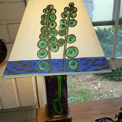 Hand=painted lamp.  Base lights up separately.