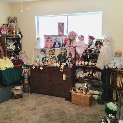 Second bedroom is filled with crafts dolls dressers and the lawyer bookcases