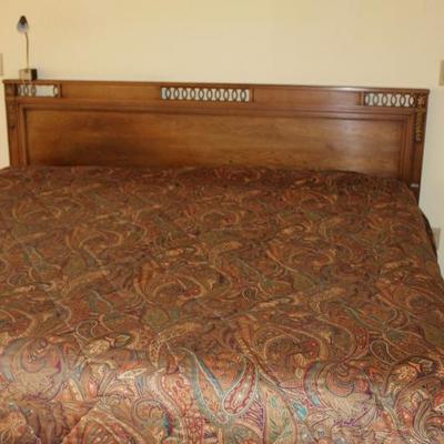 King size bed, wooden headboard with elegant details.
