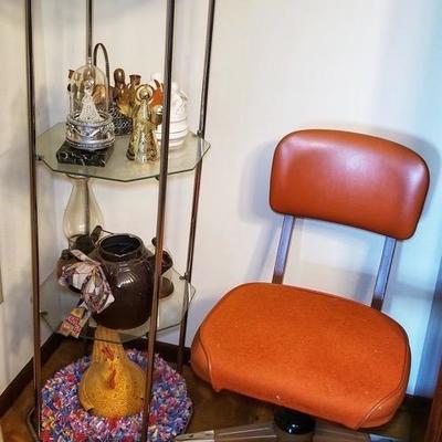 Retro Steelecase style rolling office chair in orange, vintage glass and brass display shelf  