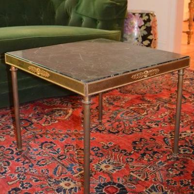 One of a pair of marble top tables