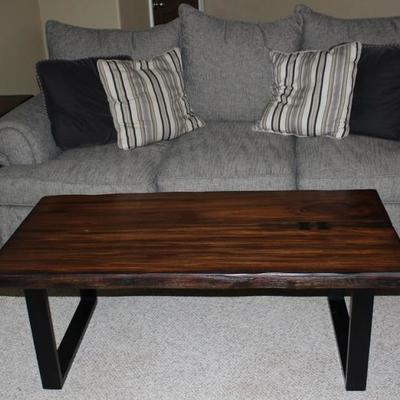 Rustic Slab Wooden Black Steel Base Coffee Table and Matching End Table shown with Berndhart Gray Tweed 3 Cushion Sofa with 3 loose plush...