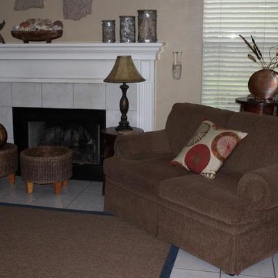 Family Room View showing 2 Round Wicker Ottomans with Large Wooden Ball, Sisal Rug and First Act by Highland House Loveseat