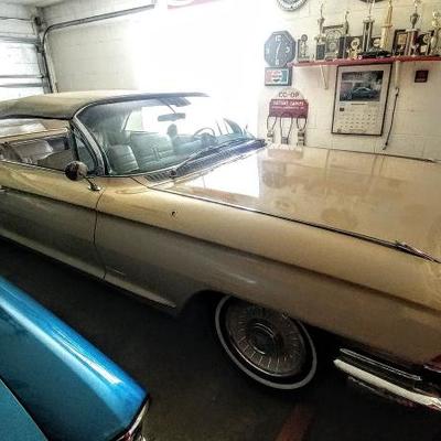 1961 Cadillac Convertible. Butternut yellow with white interior. Original paint in great shape, but not car show condition.  Owned since...