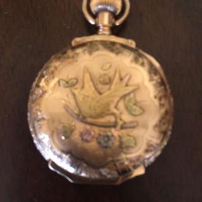 Vintage 14K Gold Pocket Watch.  Hand cut design of flowers, leaves, and birds.  That case is completely hand tooled.  It has white,...