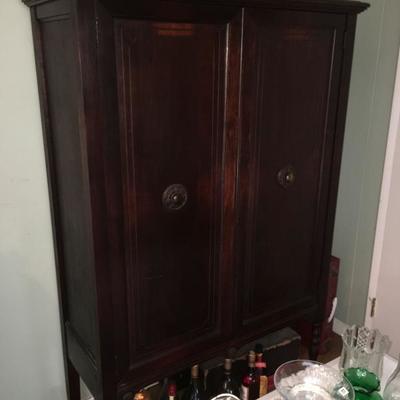 Standing early american storage cabinet.  Perfect for extra storage.  Shelving inside.  Available for presale. $400