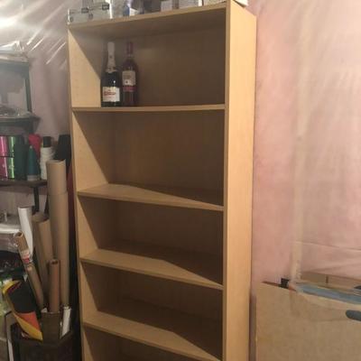 One of 3 wooden storage shelves, multiple others