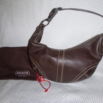 Pristine designer Soho Hobo purse by Coach with dust jacket in brown..